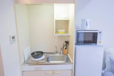 a small kitchen with a sink and a refrigerator at \u9591\u9759\u306a\u4f4f\u5b85\u8857_\u6696\u304b\u304f\u5c45\u5fc3\u5730\u306e\u826f\u3044\u30c7\u30b6\u30a4\u30f3 YoW-4 in Tokyo