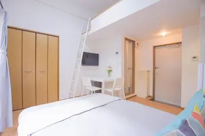 a bedroom with a bed and a desk and a ladder at \u9591\u9759\u306a\u4f4f\u5b85\u8857_\u6696\u304b\u304f\u5c45\u5fc3\u5730\u306e\u826f\u3044\u30c7\u30b6\u30a4\u30f3 EoE-2 in Tokyo