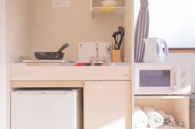 a kitchen with a white microwave and a sink at \u9591\u9759\u306a\u4f4f\u5b85\u8857_\u6696\u304b\u304f\u5c45\u5fc3\u5730\u306e\u826f\u3044\u30c7\u30b6\u30a4\u30f3 SoW-2 in Tokyo