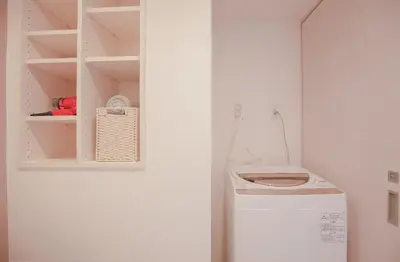 a laundry room with a washing machine and a shelf at 10min walk to Shinjuku YEoE-2 in Tokyo