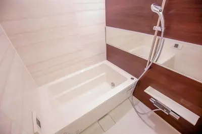 a white bath tub in a bathroom with wooden walls at 10min walk to Shinjuku YEoE-2 in Tokyo