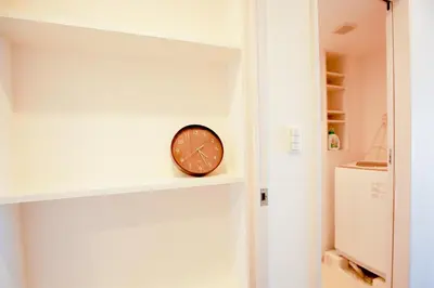 a clock sitting on a shelf in a room at 10min walk to Shinjuku YEoE-2 in Tokyo