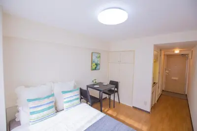 a hotel room with a bed and a table at walk to Higahsi Shinjuku sta. SYW in Tokyo