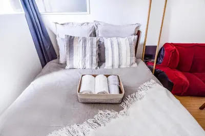 a bed with a tray with two towels on it at walk to Higahsi Shinjuku sta. EoQ in Tokyo