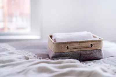 a box of towels sitting on top of a bed at walk to Higahsi Shinjuku sta. EoQ in Tokyo