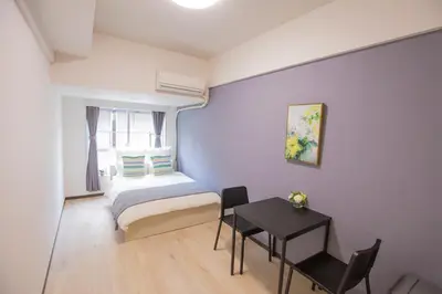 a small bedroom with a bed and a table at walk to Higahsi Shinjuku sta. EYW in Tokyo