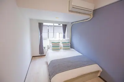 a small room with a bed with a window at walk to Higahsi Shinjuku sta. EYW in Tokyo