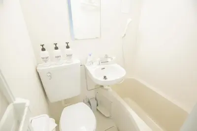 a white bathroom with a sink and a toilet and a tub at walk to Higahsi Shinjuku sta. EYW in Tokyo