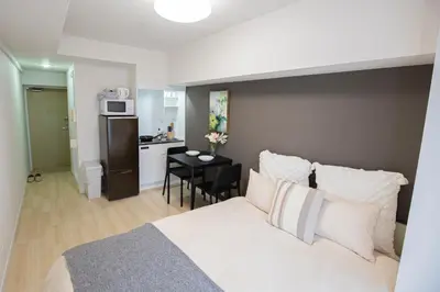 a hotel room with a bed and a kitchen at walk to Higahsi Shinjuku sta. LYo in Tokyo