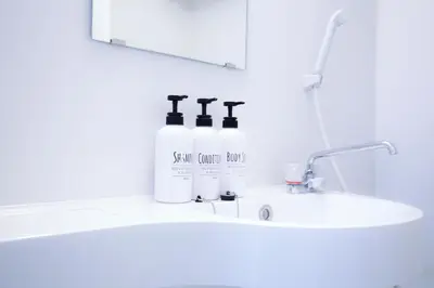 a bathroom sink with two bottles of soap on it at walk to Higahsi Shinjuku sta. LYo in Tokyo