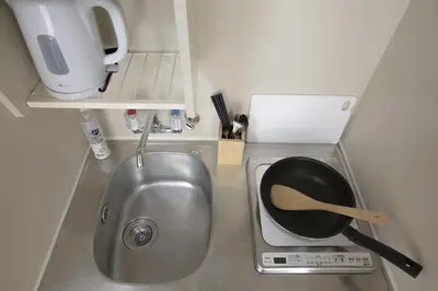 a kitchen with a sink and a pan in it at walk to Higahsi Shinjuku sta. WoSI in Tokyo