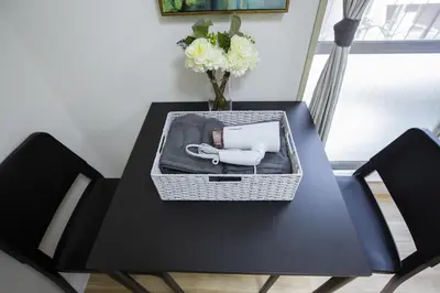 a black table with a white phone and flowers on it at walk to Higahsi Shinjuku sta. WoSI in Tokyo