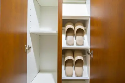 a closet with a pair of shoes on the shelves at walk to Higahsi Shinjuku sta. SIoQ-2 in Tokyo