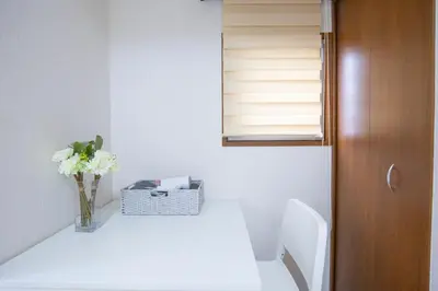 a bathroom with a vase of flowers on a table at walk to Higahsi Shinjuku sta. SIoQ-2 in Tokyo