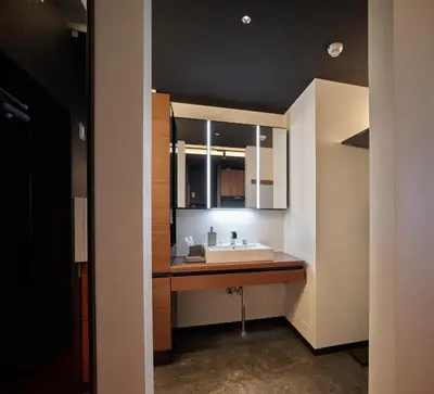 a bathroom with a sink and a mirror at Acoustic GARAGE by Tranova in Tokyo