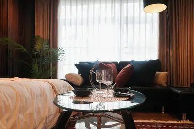 a living room with a couch and a glass table at Acoustic GARAGE by Tranova in Tokyo