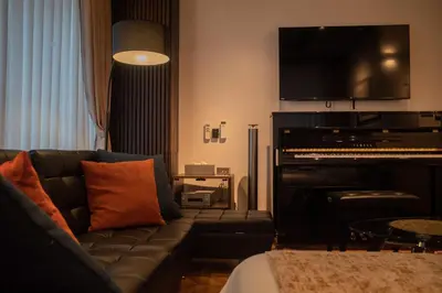 a living room with a couch and a piano at Acoustic GARAGE by Tranova in Tokyo