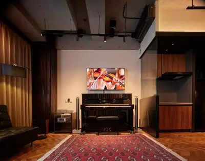 a living room with a piano with a flat screen tv at Acoustic GARAGE by Tranova in Tokyo