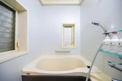 a white bathroom with a bath tub and a sink at Premier suite Shibuya Yoyogi front in Tokyo