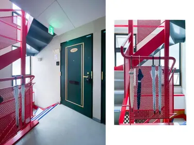 a room with a red staircase and a door at We Guest House in Tokyo
