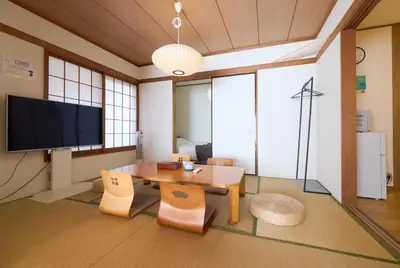 a living room with a table and chairs and a tv at Tokyo Central Shinjuku-ward Japanese Tatami House 2DK-\u65b0\u5bbf03 in Tokyo