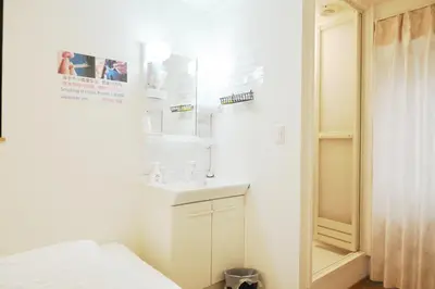 a white bathroom with a sink and a mirror at Hananogo Ikebukuro - Vacation STAY 09224v in Tokyo