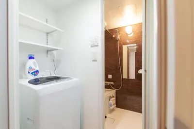 a small bathroom with a sink and a shower at Trym\u62bc\u4e0a in Tokyo