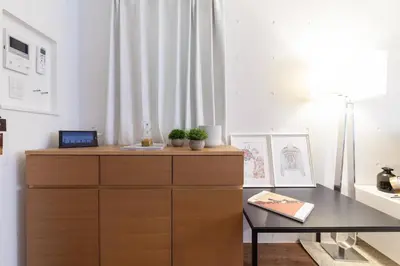 a dresser and a table in a room at Trym\u62bc\u4e0a in Tokyo