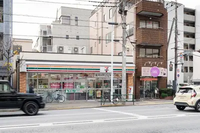 a truck driving down a street in a city at Trym\u62bc\u4e0a in Tokyo