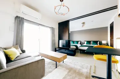 a living room with a couch and a bed at MAT Oshiage in Tokyo