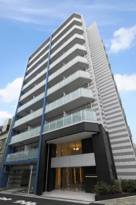 a tallartment building with a blue sky in the background at MAT Oshiage in Tokyo