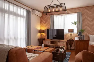 a living room with a couch and a flat screen tv at \u5317\u65b0\u5bbf1-11-10 in Tokyo