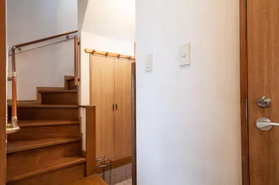 a hallway with stairs and a door to a room at \u5317\u65b0\u5bbf1-11-10 in Tokyo
