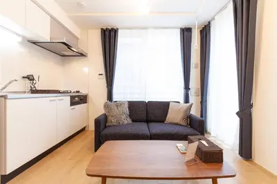 a living room with a couch and a table at Legaland\u5b66\u7fd2\u9662\u4e0b in Tokyo