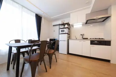 a kitchen and dining room with a table and chairs at Legaland\u5b66\u7fd2\u9662\u4e0b in Tokyo