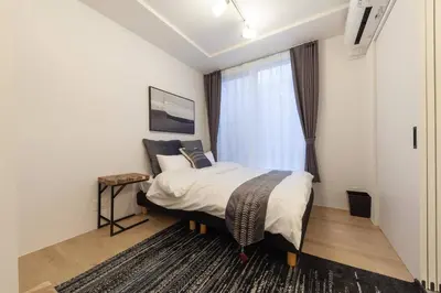 a bedroom with a large bed and a window at Legaland\u5b66\u7fd2\u9662\u4e0b in Tokyo