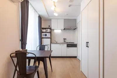 a small kitchen and dining room with a table and chairs at Legaland\u5b66\u7fd2\u9662\u4e0b in Tokyo