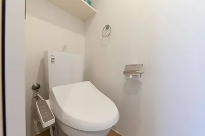 a bathroom with a white toilet and a phone at Legaland\u5b66\u7fd2\u9662\u4e0b in Tokyo
