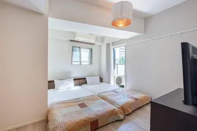 a bedroom with a bed and a flat screen tv at \u6e0b\u8c37\u30d2\u30eb\u30c8\u30c3\u30d7 in Tokyo