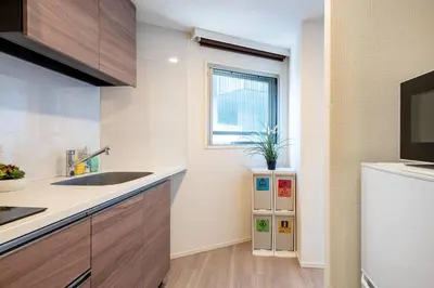 a kitchen with a sink and a refrigerator at \u6e0b\u8c37\u30d2\u30eb\u30c8\u30c3\u30d7 in Tokyo