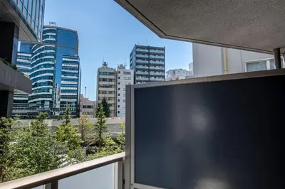 a large screen tv on a balcony in a city at \u6e0b\u8c37\u30d2\u30eb\u30c8\u30c3\u30d7 in Tokyo