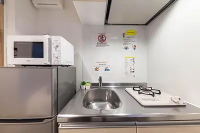 a kitchen with a stainless steel sink and a microwave at R\u30ca\u30ec\u30c3\u30b8\u4e21\u56fd bldg in Tokyo