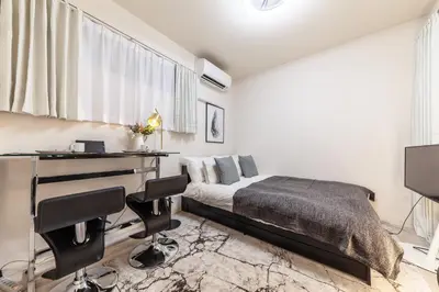 a bedroom with a bed and a desk at Villettina\u6d45\u8349 in Tokyo