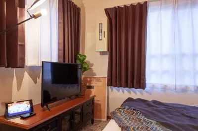 a living room with a television on a table at Villettina\u6d45\u8349 in Tokyo