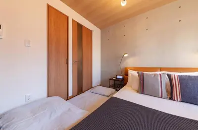 a bedroom with two beds and a window at Villettina\u6d45\u8349 in Tokyo