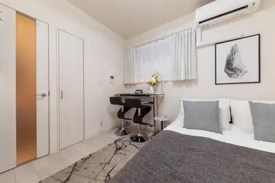 a bedroom with a bed and a desk at Villettina\u6d45\u8349 in Tokyo