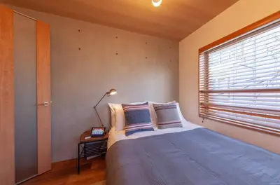 a bedroom with a bed and a window at Villettina\u6d45\u8349 in Tokyo