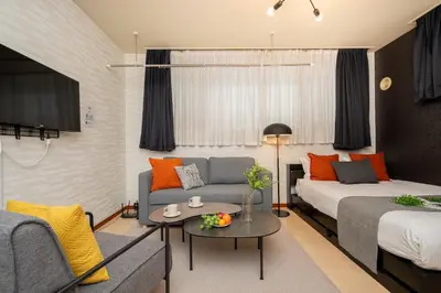 a living room with a bed and a couch at \u30b0\u30e9\u30ca\u30fc\u30c9\u516d\u672c\u6728 in Tokyo