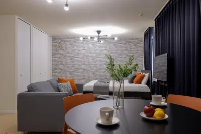 a living room with a couch and a table with fruits on it at \u30b0\u30e9\u30ca\u30fc\u30c9\u516d\u672c\u6728 in Tokyo