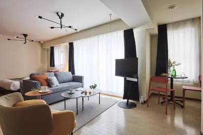 a living room with a couch and a tv at \u30b0\u30e9\u30ca\u30fc\u30c9\u516d\u672c\u6728 in Tokyo